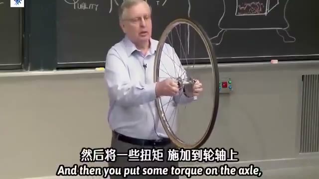 Patrick Winston holding a bicycle wheel during the prop demonstration